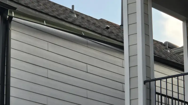 Close view of a gutter edge where the roof meets the siding