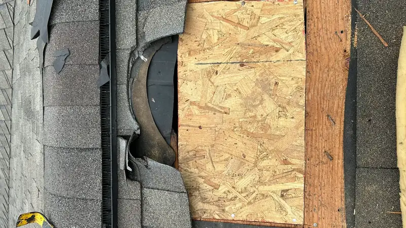 Replacement decking board over a repaired section of roof