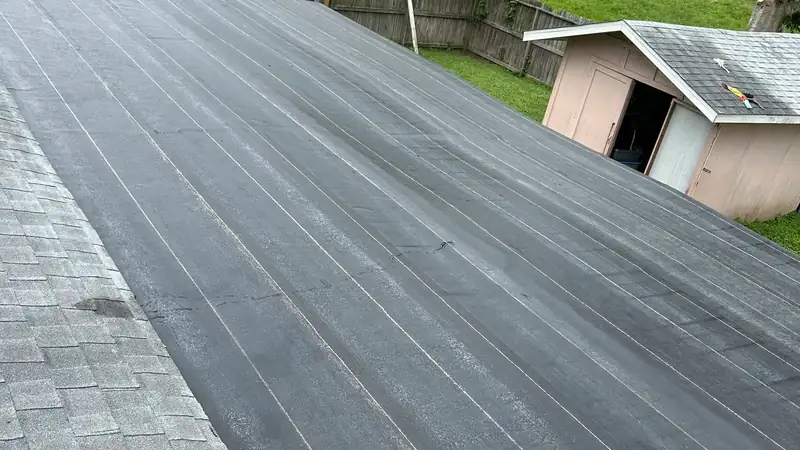 Overview of a residential shingle roof slope after repair work